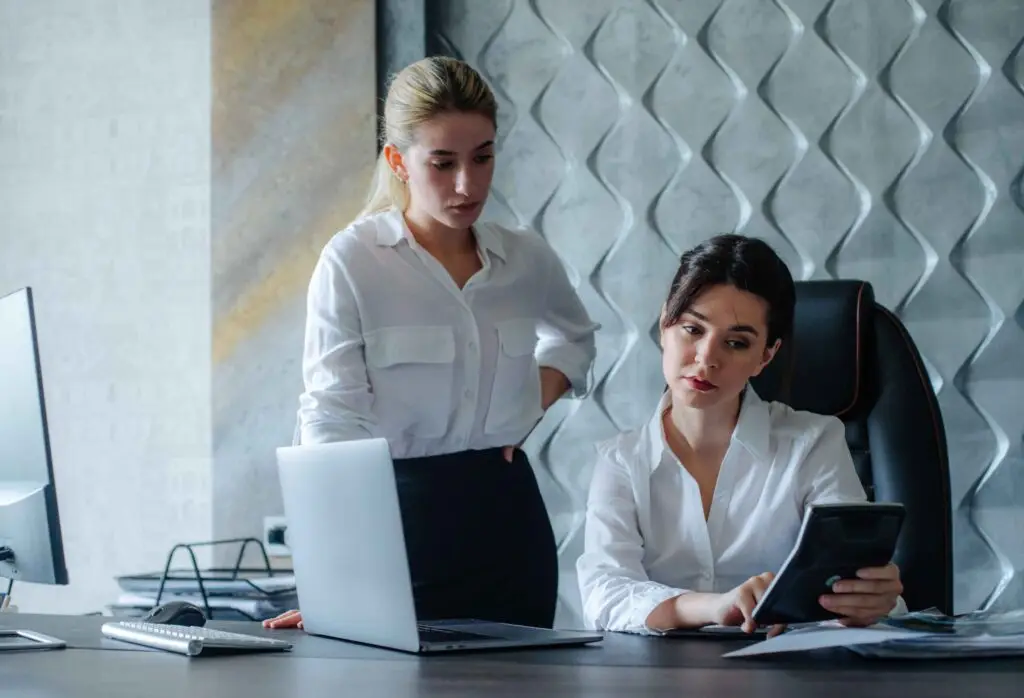 two women looking at a tablet